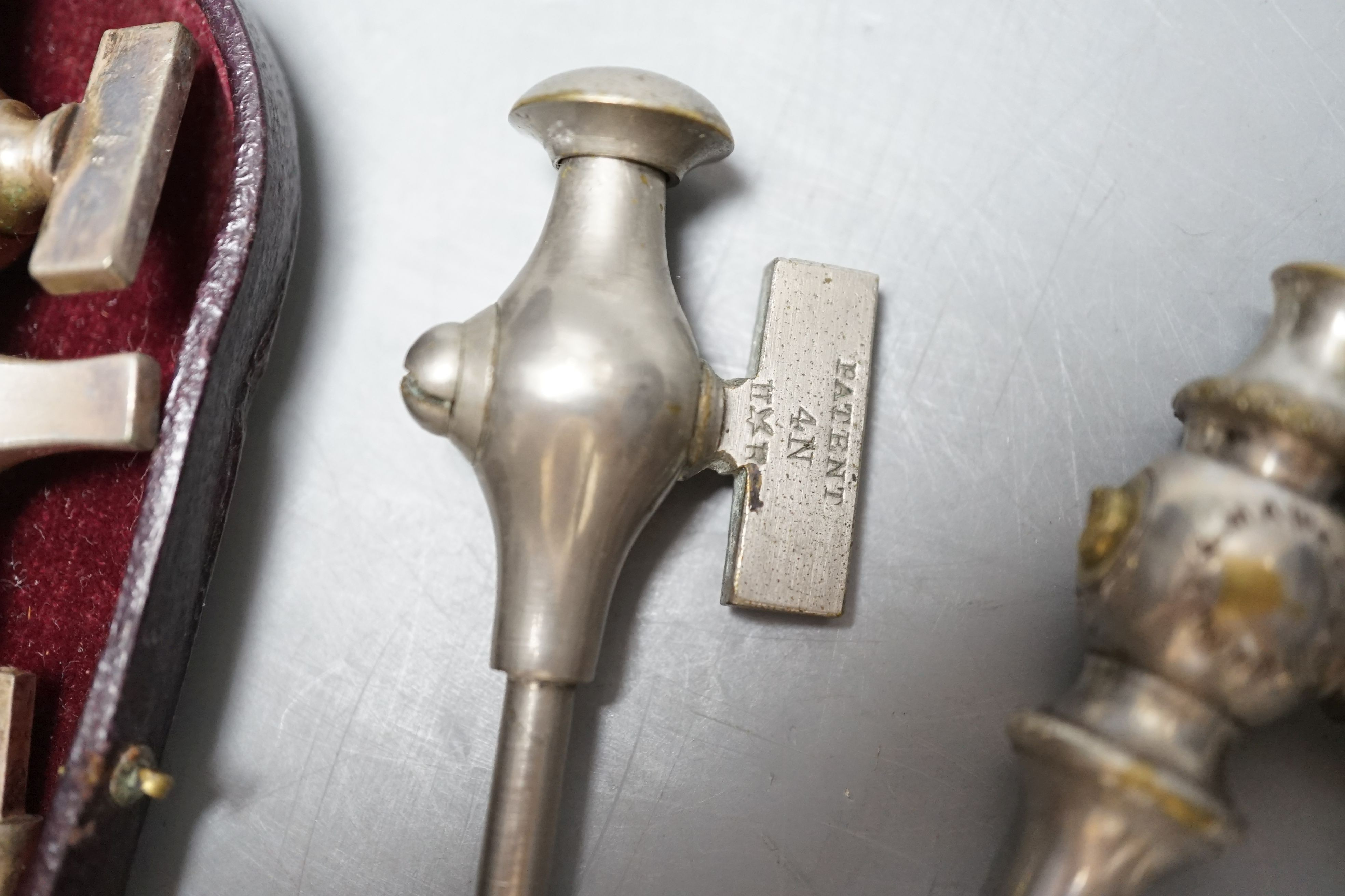 An S. Maw & Son champagne tap and four others, one in original leather case